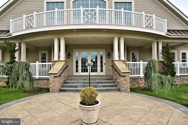 rear view of house with a porch and french doors