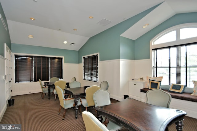 dining space with vaulted ceiling and carpet