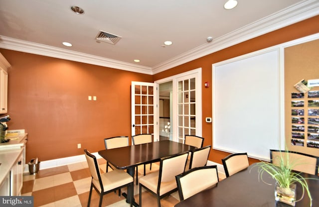 dining room featuring crown molding and french doors