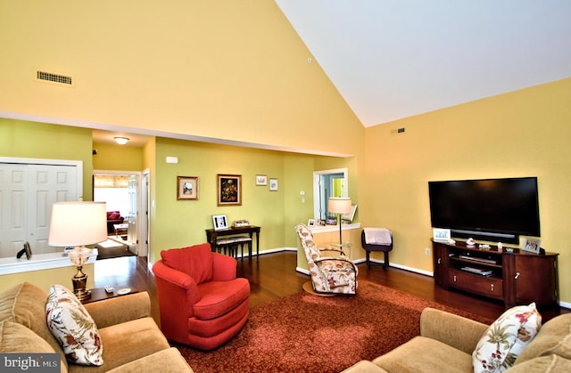 living room with hardwood / wood-style flooring and high vaulted ceiling