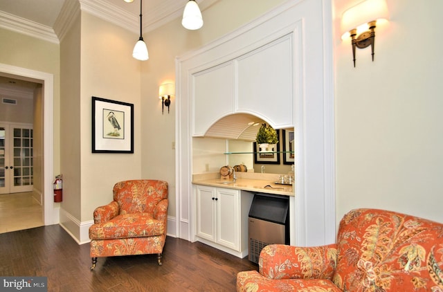 living area featuring dark wood-type flooring, ornamental molding, and french doors