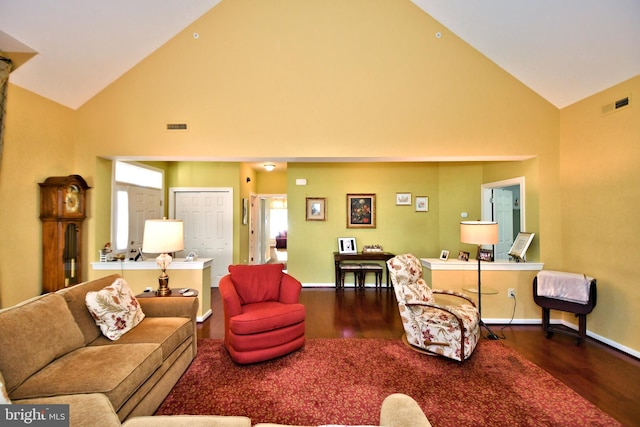 living room with high vaulted ceiling and dark hardwood / wood-style floors