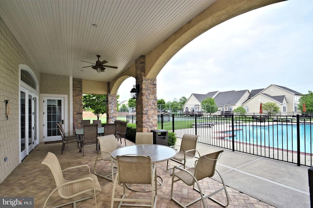 view of patio featuring a fenced in pool and ceiling fan