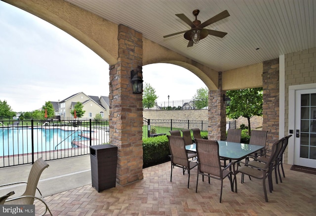 view of patio / terrace featuring a fenced in pool and ceiling fan