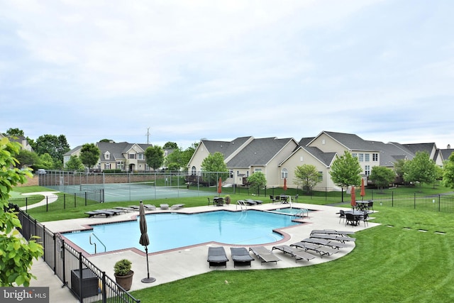 view of swimming pool with a lawn and a patio area