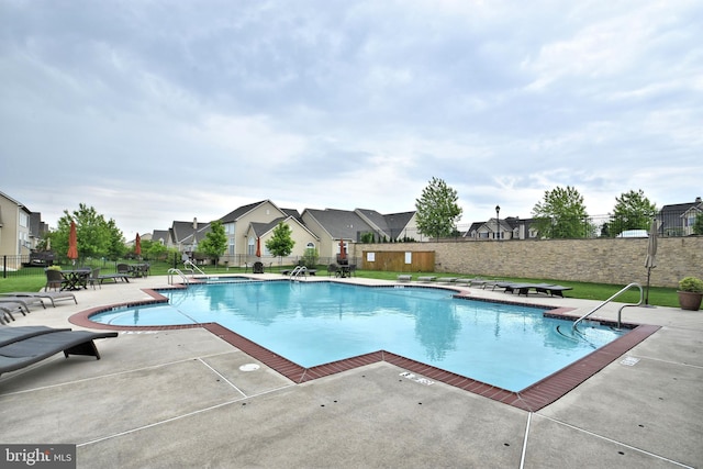 view of swimming pool with a patio