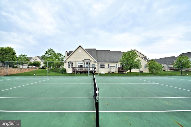 view of tennis court with a wooden deck