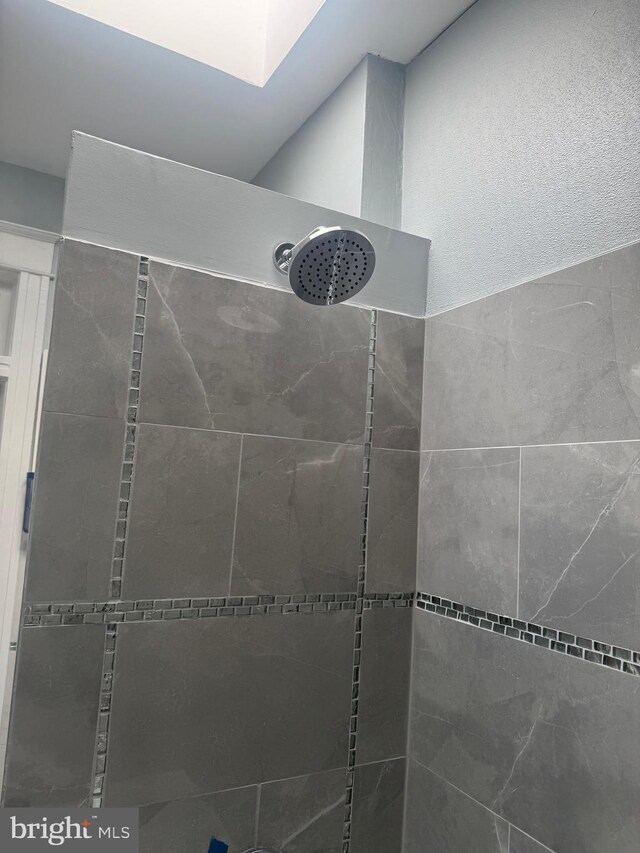 interior space with tiled shower