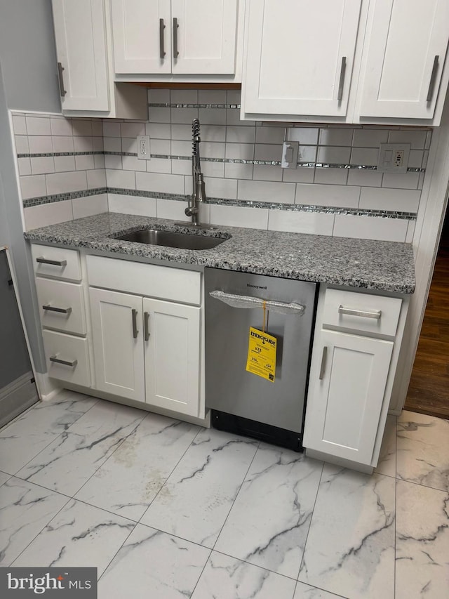 kitchen with white cabinetry, sink, dishwasher, and stone countertops