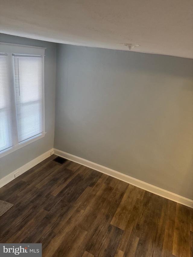 spare room featuring dark hardwood / wood-style floors