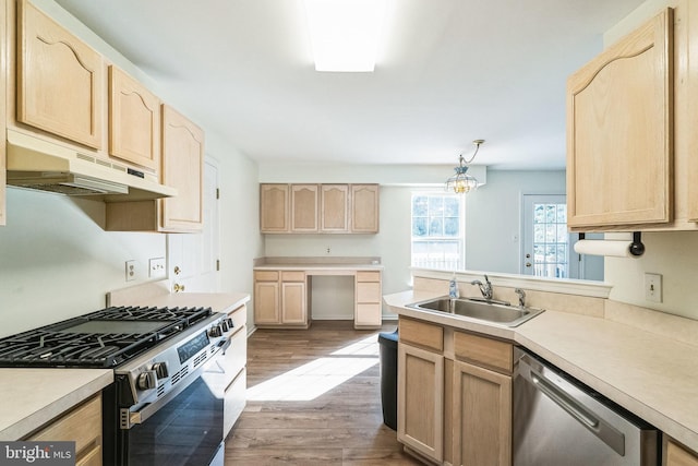 kitchen with sink, light hardwood / wood-style flooring, light brown cabinets, pendant lighting, and stainless steel appliances