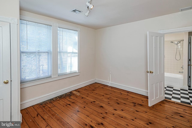 unfurnished room with hardwood / wood-style floors