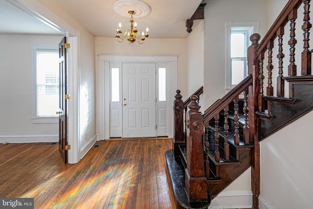 entrance foyer with a chandelier and dark hardwood / wood-style flooring