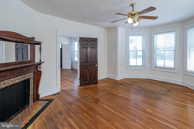 unfurnished living room featuring ceiling fan and wood-type flooring