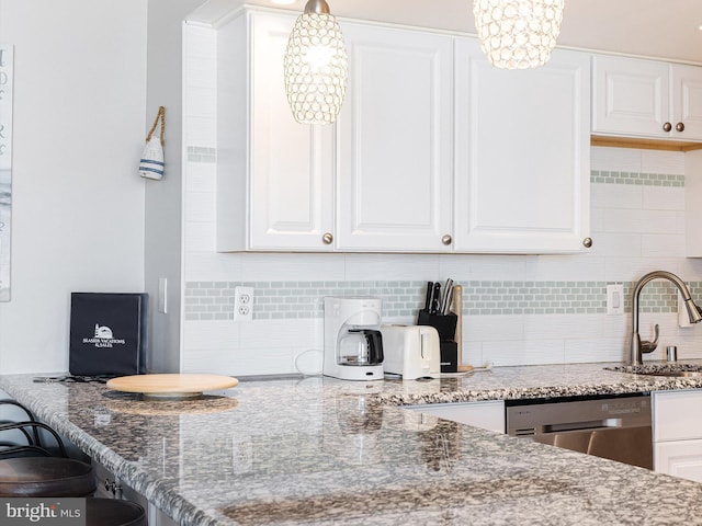 kitchen with white cabinetry, decorative light fixtures, dishwasher, and sink