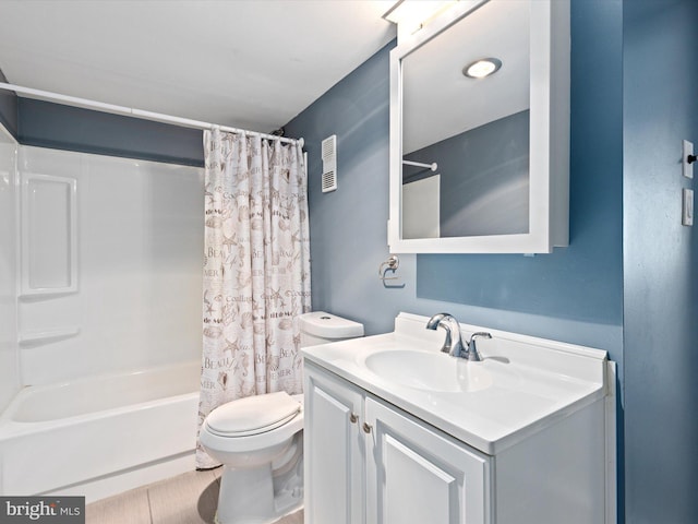 full bathroom with vanity, shower / tub combo, and toilet