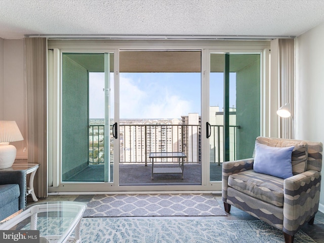 interior space with expansive windows, plenty of natural light, and a textured ceiling