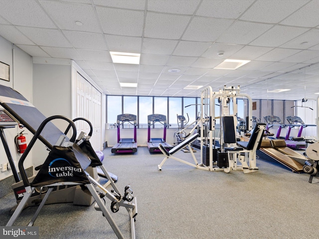 gym with a paneled ceiling