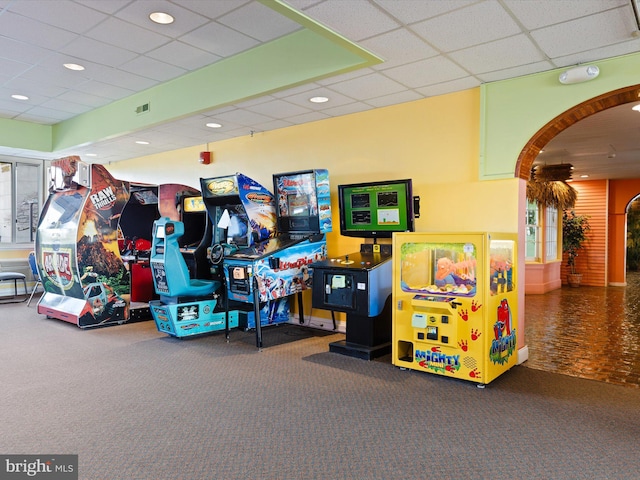 rec room featuring carpet floors and a drop ceiling