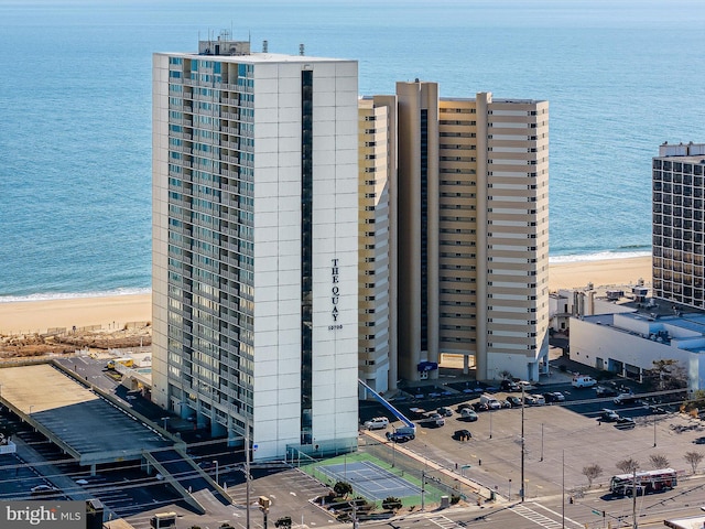 exterior space featuring a water view and a beach view