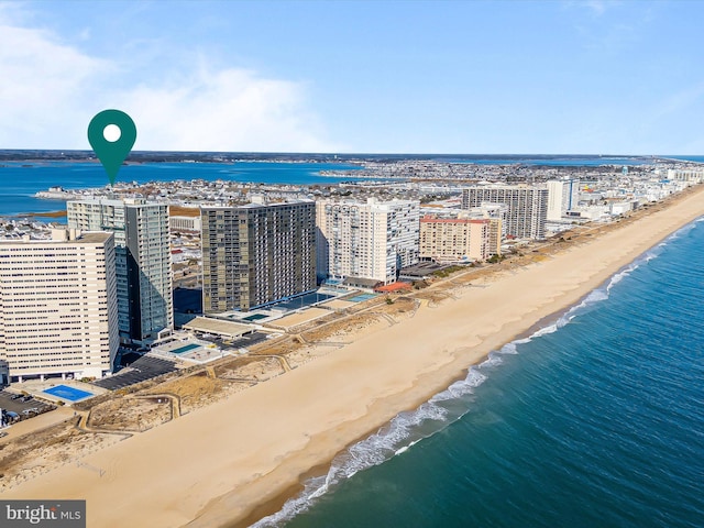 birds eye view of property featuring a beach view and a water view