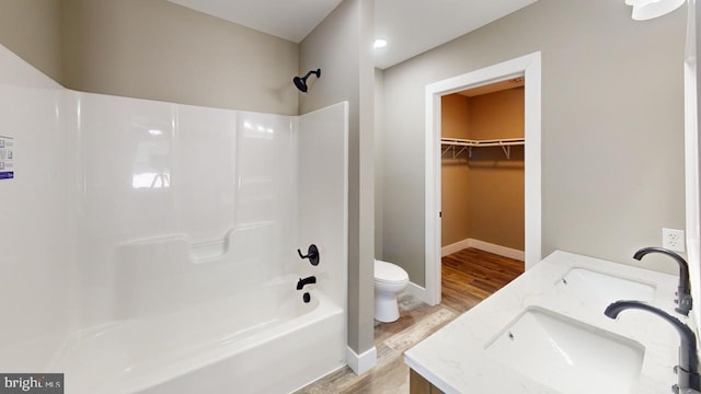 full bathroom featuring shower / bathtub combination, vanity, toilet, and hardwood / wood-style floors