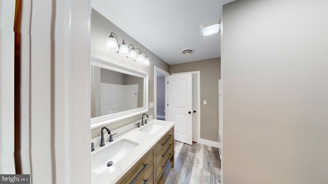 bathroom with vanity and hardwood / wood-style floors