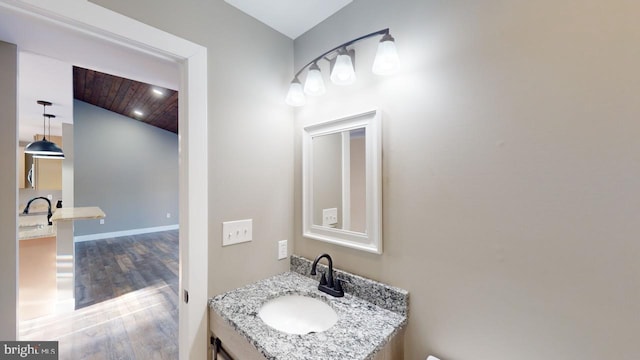 bathroom featuring vanity, hardwood / wood-style flooring, and wooden ceiling