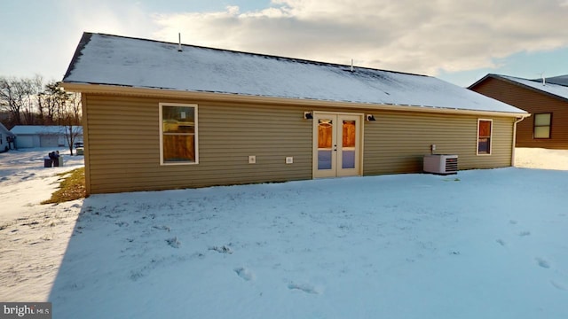 snow covered property with cooling unit