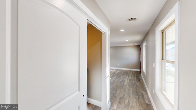 hall with wood-type flooring