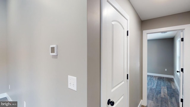 corridor with hardwood / wood-style floors