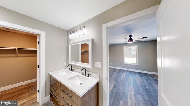 bathroom featuring hardwood / wood-style flooring, vanity, and ceiling fan