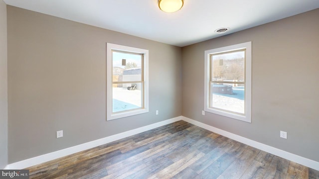 unfurnished room with dark hardwood / wood-style floors