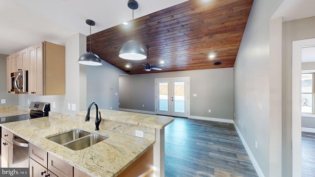 kitchen with light brown cabinetry, sink, hanging light fixtures, stainless steel appliances, and french doors