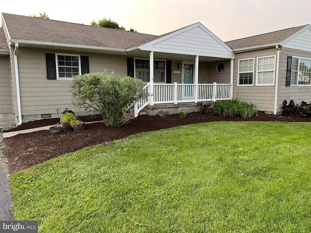 ranch-style home with a porch and a yard