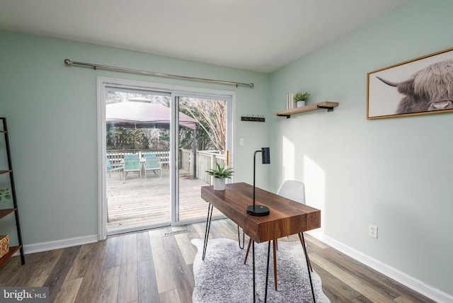 office with dark hardwood / wood-style flooring