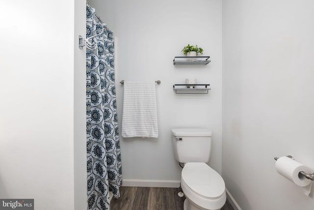 bathroom with hardwood / wood-style floors and toilet