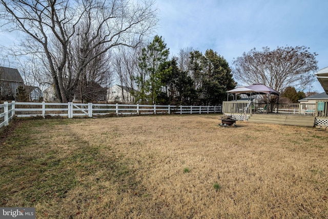 view of yard with a wooden deck and a gazebo