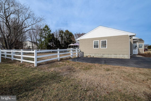 view of property exterior with a lawn