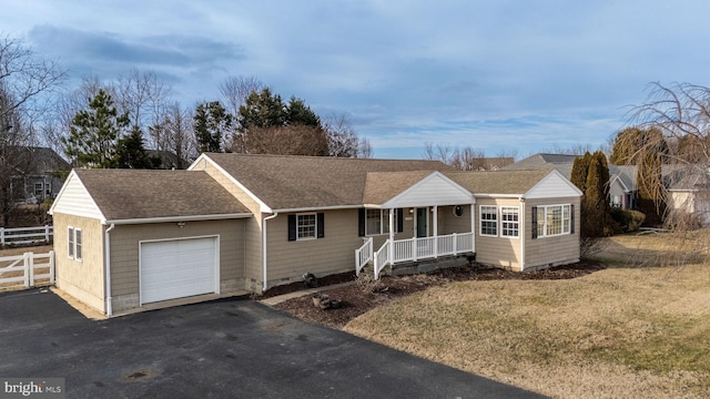 ranch-style house with a porch, a garage, and a front lawn