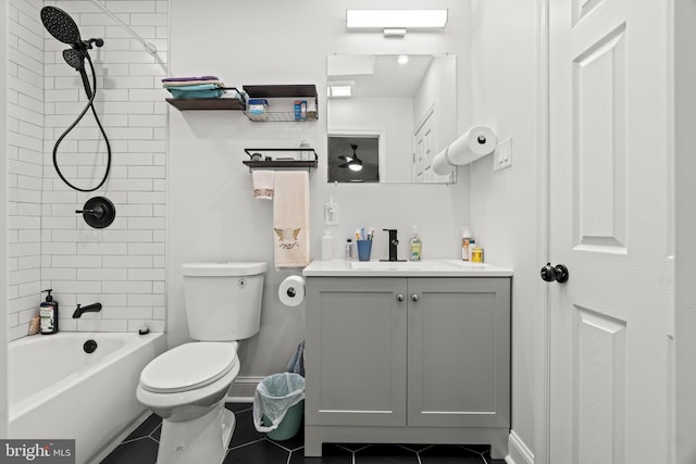 full bathroom with vanity, tiled shower / bath, tile patterned floors, and toilet