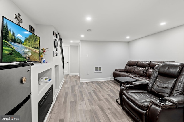 living room with light hardwood / wood-style flooring