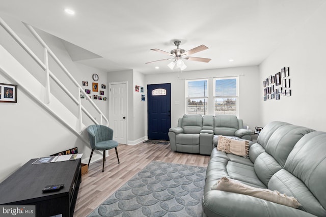 living room featuring ceiling fan and light hardwood / wood-style floors