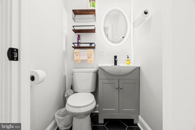 bathroom featuring tile patterned flooring, vanity, and toilet