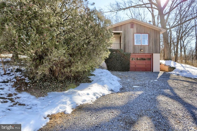 snow covered property featuring a garage