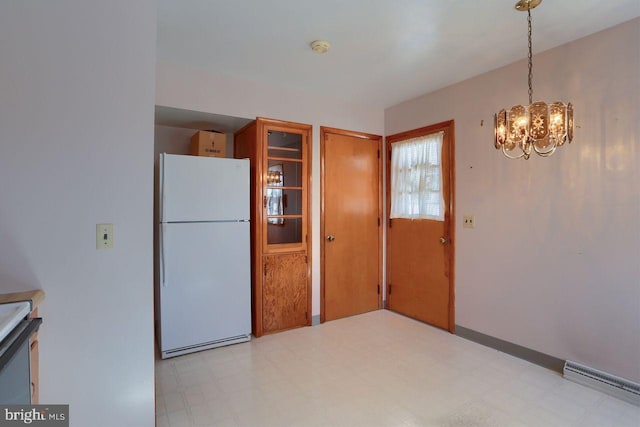 kitchen with white refrigerator, decorative light fixtures, a chandelier, and a baseboard heating unit