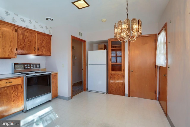 kitchen featuring electric stove, pendant lighting, a chandelier, and white refrigerator