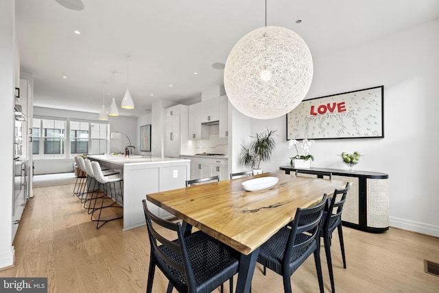 dining space featuring light hardwood / wood-style floors