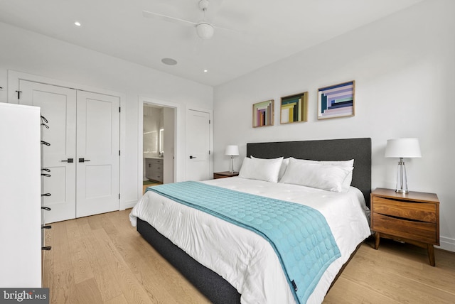 bedroom with ceiling fan, connected bathroom, and light hardwood / wood-style floors