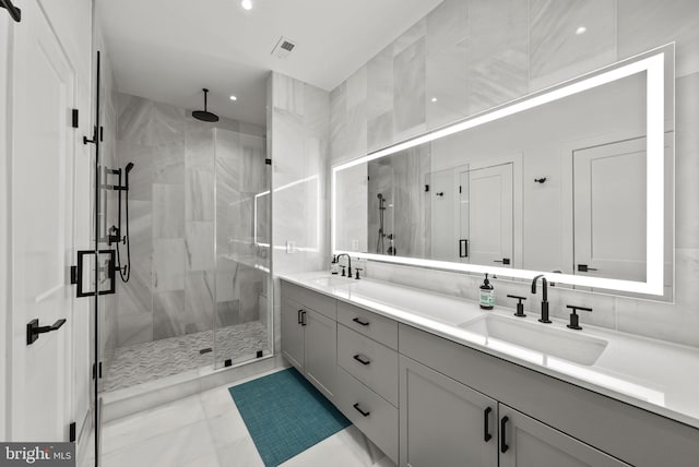 bathroom featuring vanity and an enclosed shower